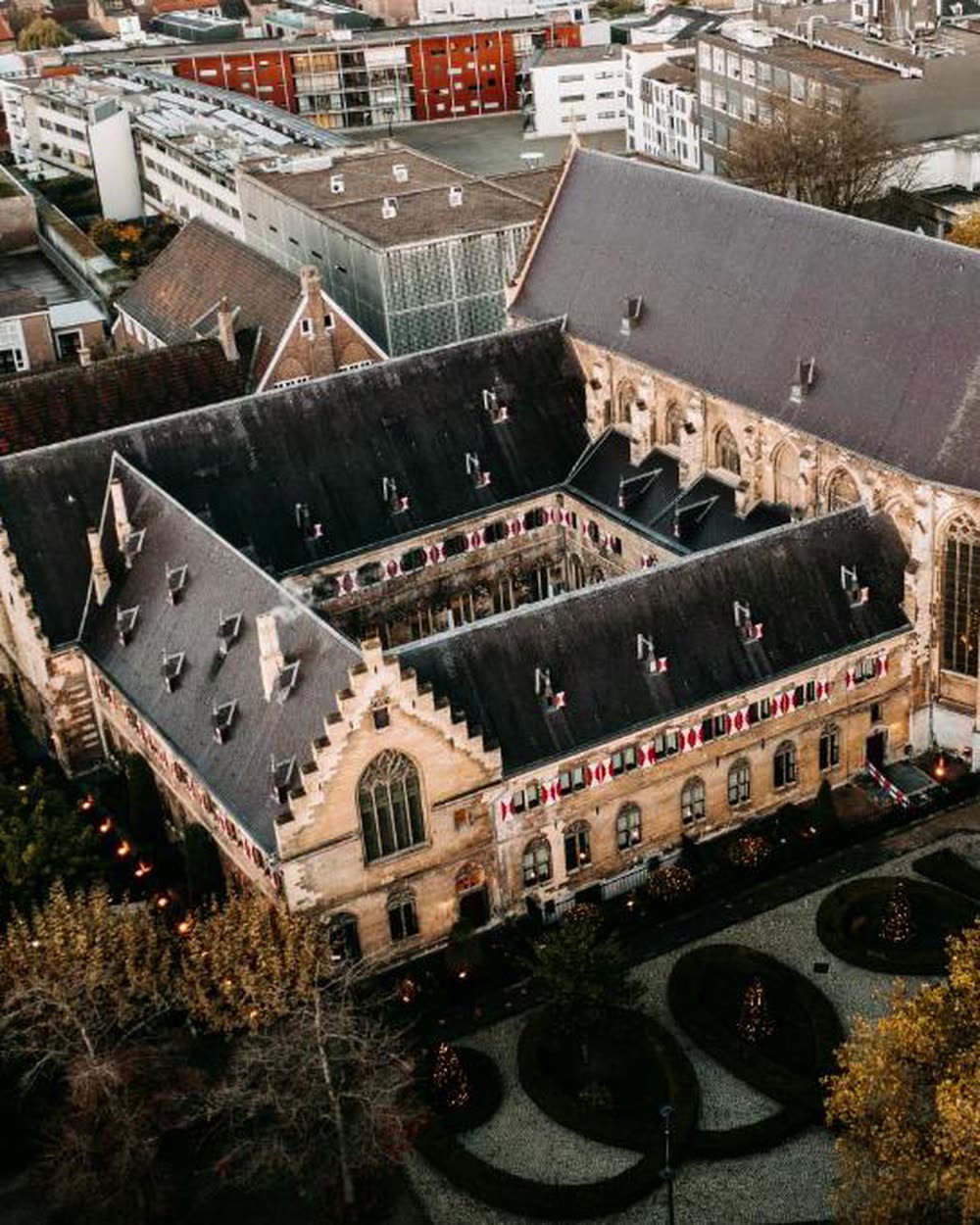 The Gothic church and cloister seen from above among autumn trees &mdash; Kruisherenhotel Maastricht, Maastricht, Netherlands