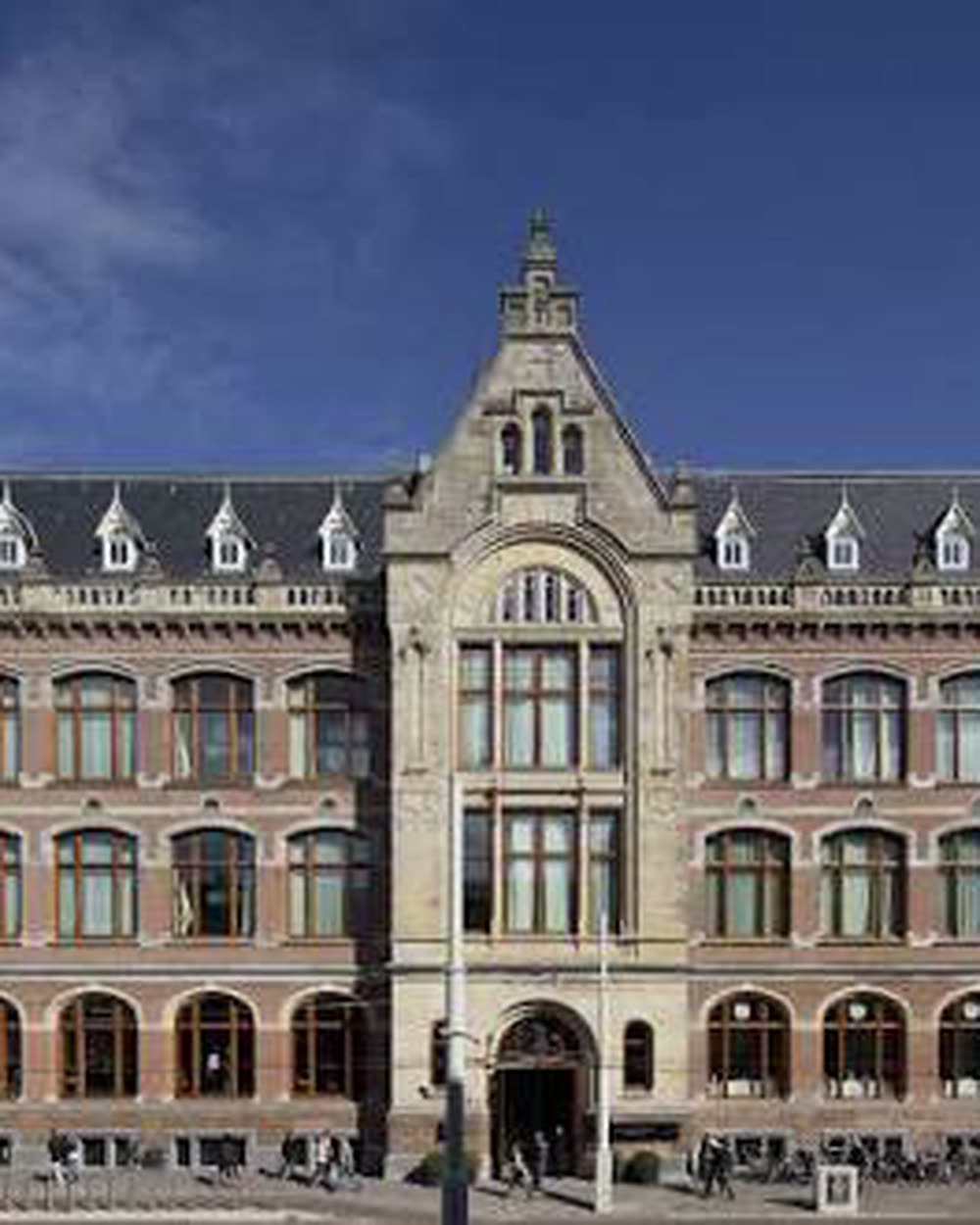 The brick facade with gables and a corner turret under a clear sky &mdash; Conservatorium Hotel, Amsterdam, Netherlands
