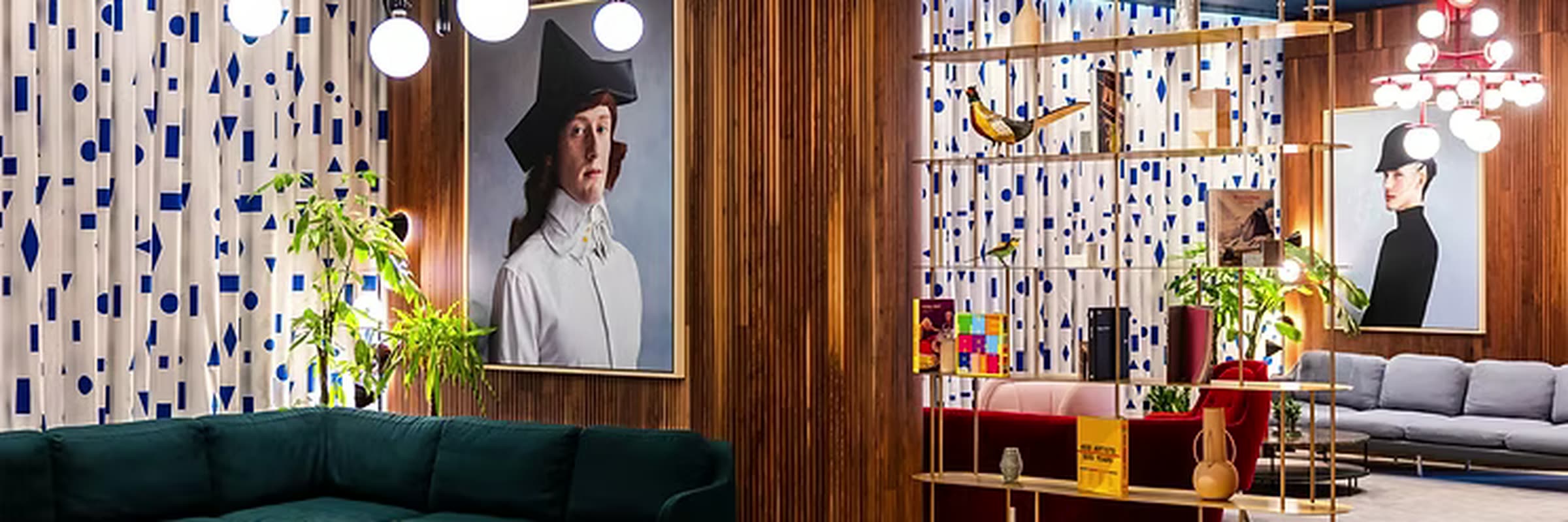 A hotel lounge with a curved timber screen and seating, seen head-on