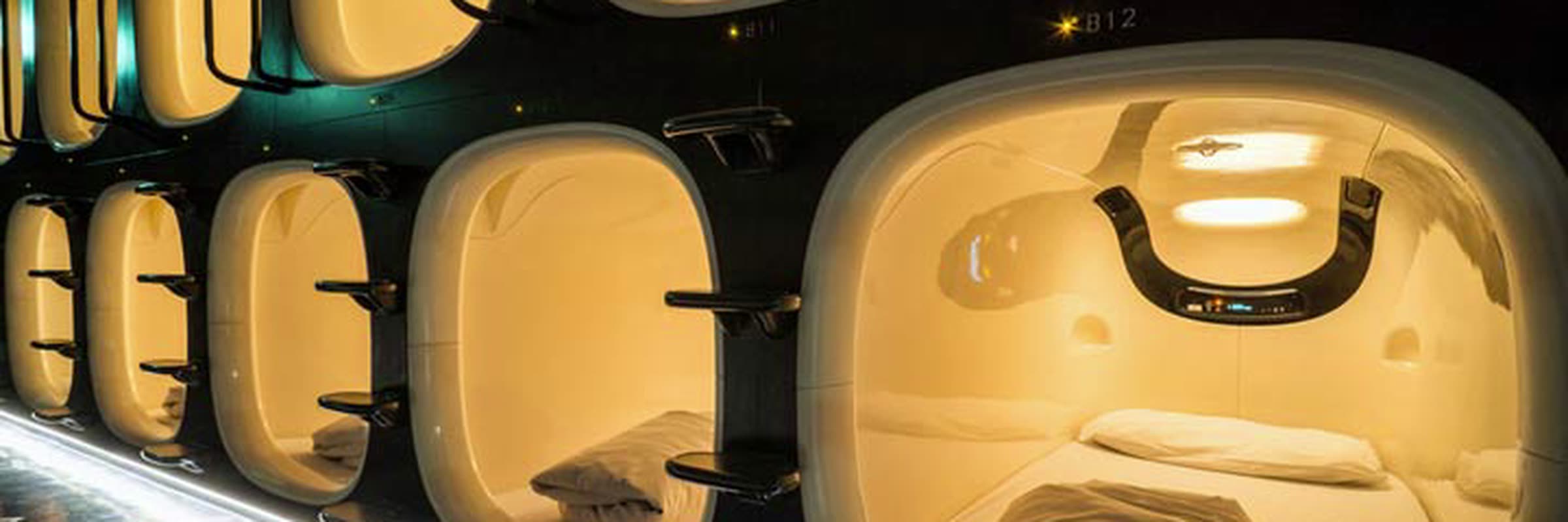 A row of capsule fronts along a lit interior corridor